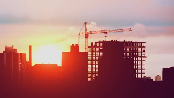 Crane Working on Construction Site Residential Building in City, Constructors Working Golden Hour alt