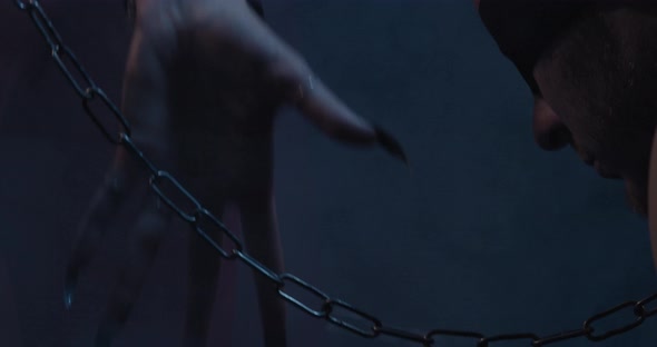 Succubus Us Touching the Chain Leash of a Blindfolded Man Smoke Film Grain alt