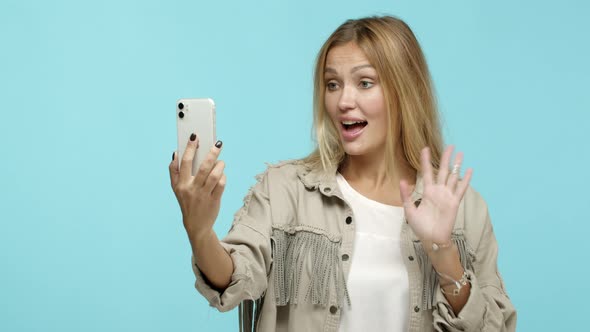 Slow Motion of Stylish Adult Woman Video Chat with Friend Saying Hello and Waving Hand at Smartphone
