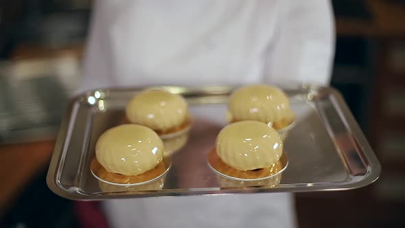 Female Confectioner in White Kittel Decorated Tasty Dessert on Kitchen alt