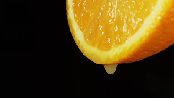 A juice drops falls from an orange