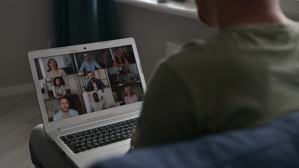 Young Man is Talking with Colleagues Online alt