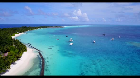 Aerial flying over sky of perfect seashore beach holiday by aqua blue sea with white sandy backgroun alt