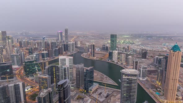Panoramic Aerial View of Business Bay Towers in Dubai Day to Night Timelapse alt