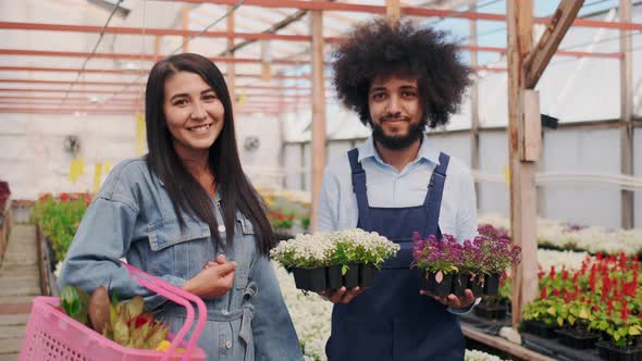 Friendly Garden Worker or Seller and Happy Customer with Purchase alt