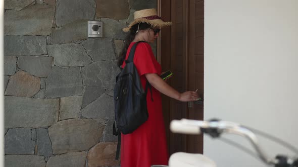 Side View Serious Young Woman Closing Door Walking to Bicycle Leaving in Slow Motion alt