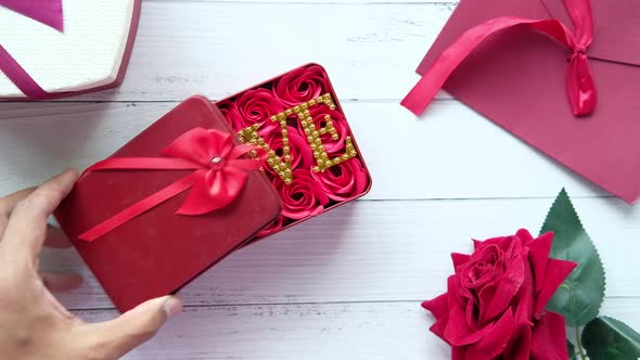 Heart Shape Gift Box and Rose Flower on Wooden Background alt