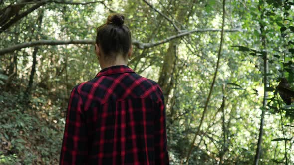 Young Woman Enjoys Trekking in Lush Tropical Rainforest alt
