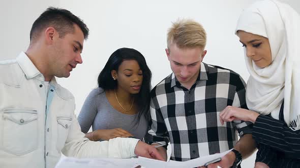 Concentrated Experienced Multiethnic Office Colleagues which Working with Reports with Datas alt