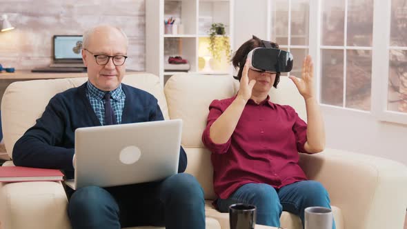 Amazed Senior Woman While Using Virtual Reality Goggles alt