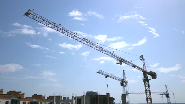 High industrial tower crane at construction site of new residential building. alt