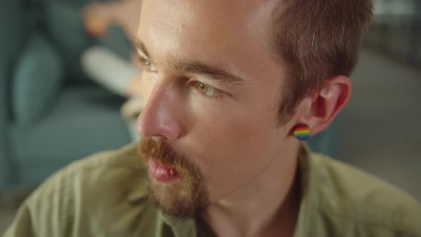Sitting in the Rest Zone in the University a Young Student is Talking to His Friend and Smiling Slow