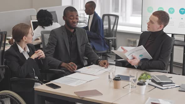 Office Workers Discussing Company Performance alt