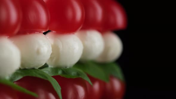 Italian salad Caprese with mini mozzarella, tomatoes cherry and arugula alt