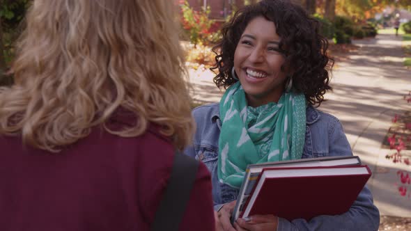 Two college students on campus looking at cell phone