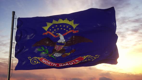Flag of North Dakota Waving in the Wind Against Deep Beautiful Sky at Sunset alt