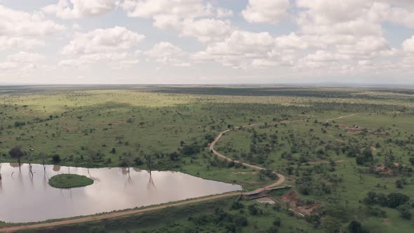 Waterhole lake in Laikipia, Kenya. High aerial drone view of Kenyan landscape alt