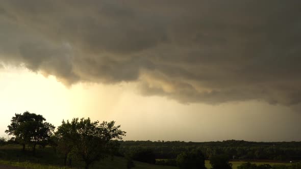 Clouds moving through the sky during severe thunderstorm in Oklahoma at sunset alt