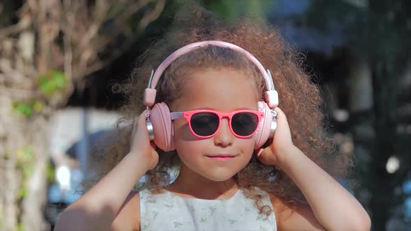 Portrait of a Child in a White Dress With Pink Glasses alt