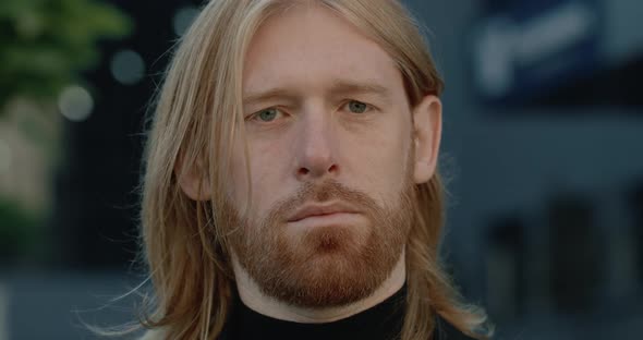 Headshot Portrait of Serious Bearded Businessman Looking To Camera. Close Up View of Long Haired Man alt