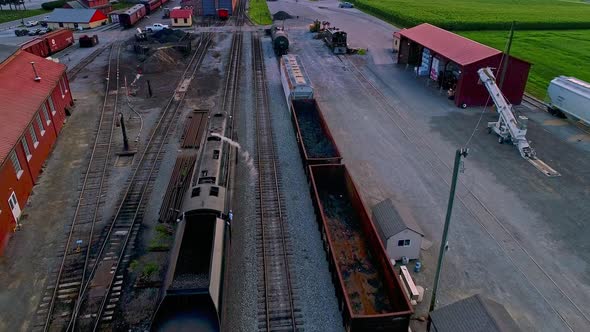 Aerial View from Slightly behind a Steam Passenger Entering a Freight Yard