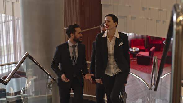 Business Team Going Upstairs in the Hotel alt