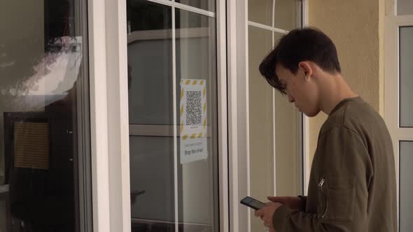 QR code on the doors at the entrance to the building. Scanning the QR code on the display  alt