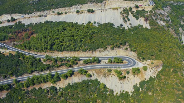 Aerial View of Hairpin Bend Road in Mountains alt