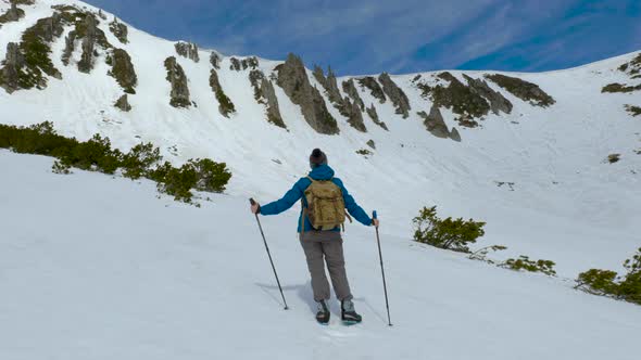 Young Woman with a Backpack Travels in the Mountains alt