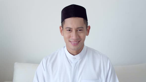 Portrait handsome Muslim man wearing traditional clothing is laughing