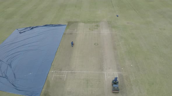 Cricket Pitch Being Prepared with Rollers