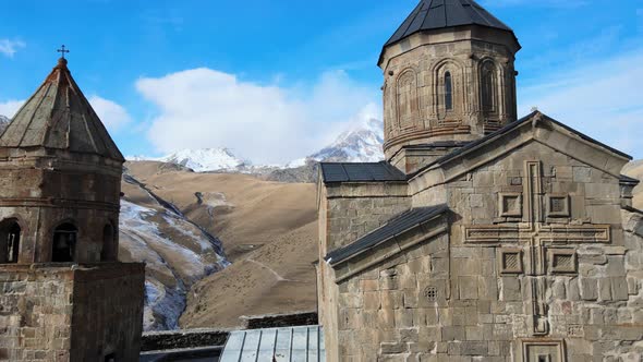 Aerial Drone Shot of Gergeti Trinity Monastery Kazbegi Georgia with Beautiful Mountains