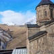Aerial Drone Shot of Gergeti Trinity Monastery Kazbegi Georgia with Beautiful Mountains - VideoHive Item for Sale