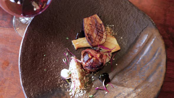 Top down view of aubergine, mushroom & fig fine dining with red wine alt