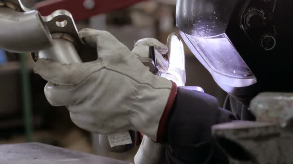 Welding Process. Worker Doing Welding Job. A Man In Helmet Doing Argon Welding Parts