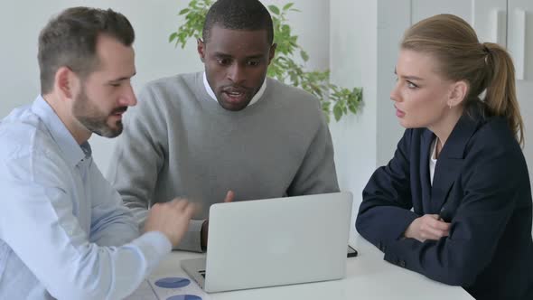 Business People Arguing While Using Laptop in Office alt
