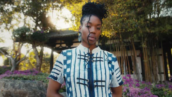 Stylish AfricanAmerican Woman in Fashionable Clothes Standing in Front of a Chinese Building alt