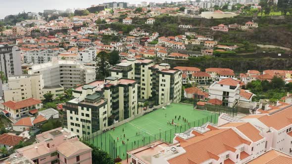 Aerial View of Charming Village on the Edge of Shoreline Washed with the Ocean alt