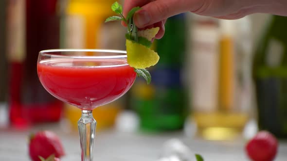 Glass with Red Cocktail. alt