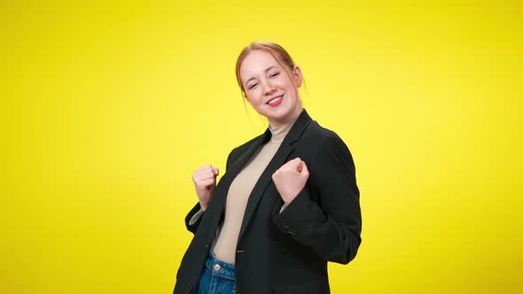 Positive Excited Young Businesswoman Making Victory Gesture Posing at Yellow Background alt