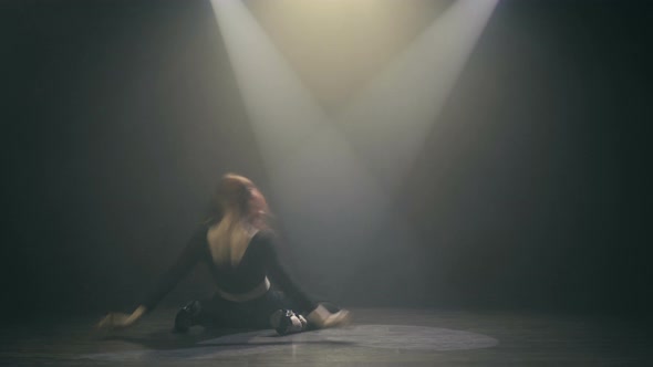 Beautiful Young Woman Dancing Hip-Hop On Stage In The Rays Of Light And In The Smoke alt