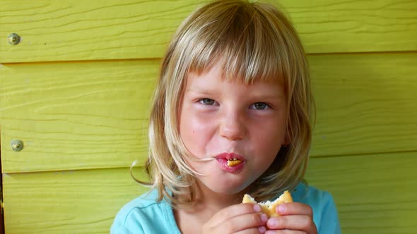 Blonde Girl Eats Cookies Portrait
