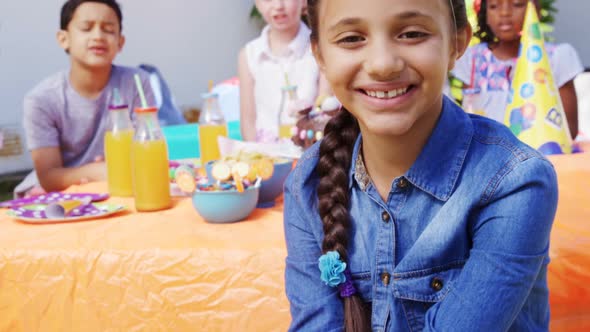 Girl sitting with the friends in the backyard of house 4k alt
