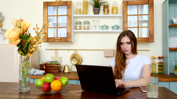 Pretty Young Woman Studying At Home, Watching Lesson Online.