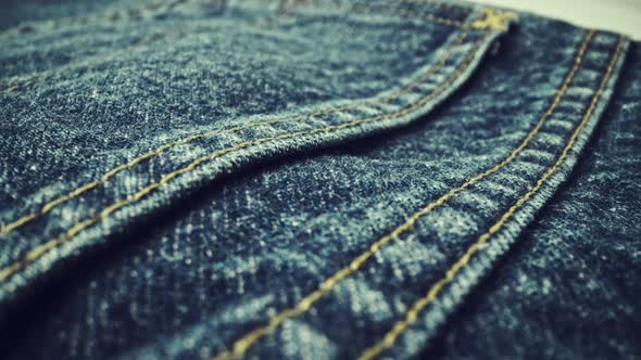 Extreme Detailed of Blue Denim Jeans Texture in Dolly Shot Over Cloth Surface alt