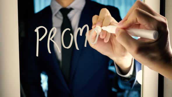 Smart Business Man Writing the Word PROMOTION on the Mirror Board alt