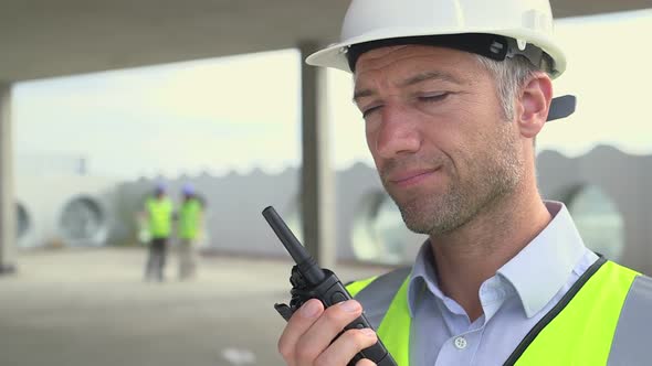 Man using walkietalkie at construction site