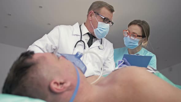 Doctors of the Emergency Department Provide Assistance To a Patient During a Severe Attack alt