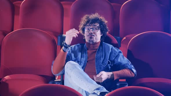 Cinema Hall with a Man Laughing Hard at the Movie alt