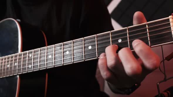 Young Man Playing Acoustic Guitar While Sitting Sofa Home Recording Studio alt